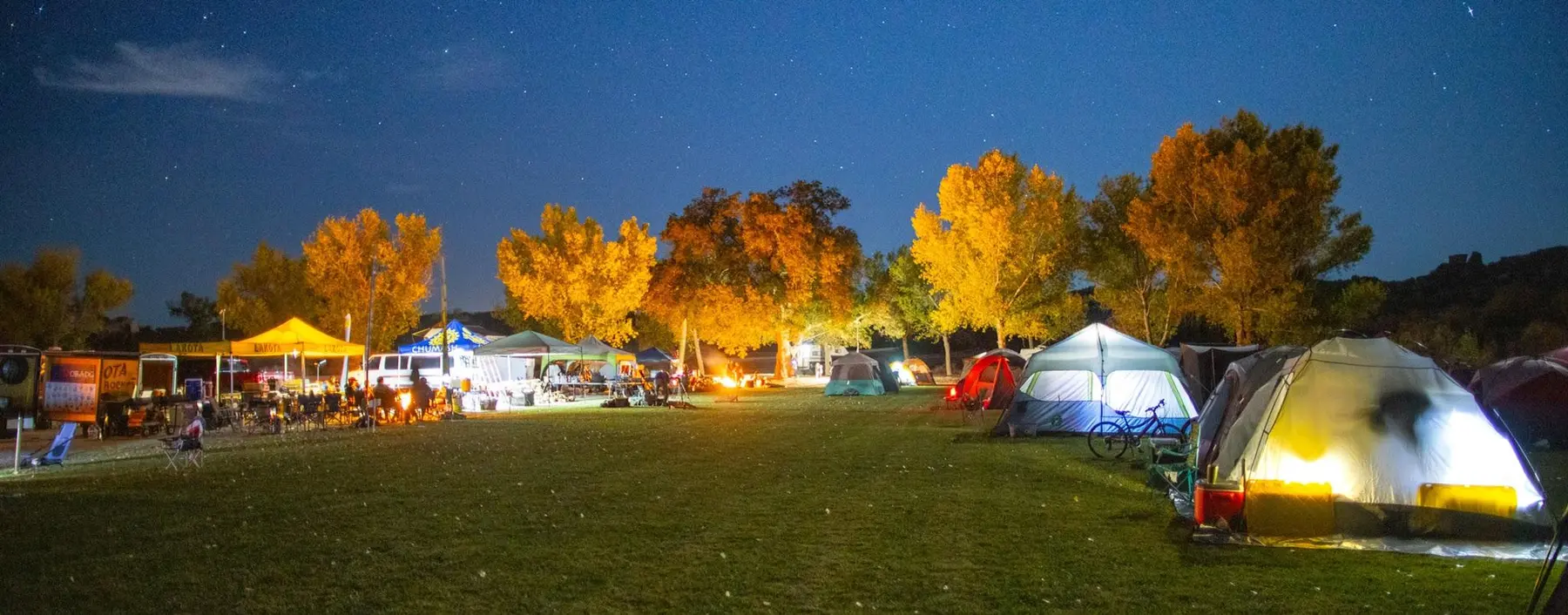 Wildcat tents glowing at night